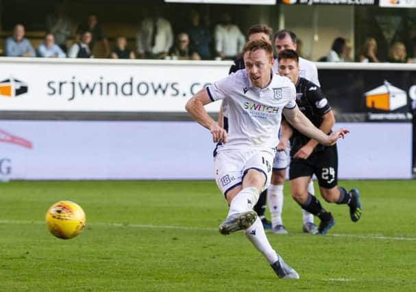 Danny Johnson converts his second penalty of the night to salvage a draw for Dundee at East End Park. Picture: Bruce White/SNS