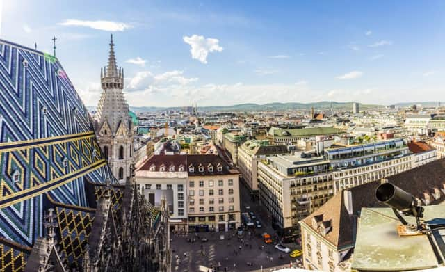 A panoramic view of the city with the coloured Stephansdom cathedral roof in the foreground