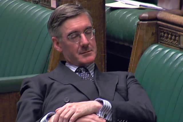 Jacob Rees-Mogg outstretched across the front benches of Parliament. Picture: PA