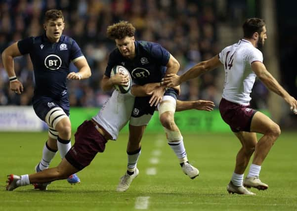 Georgia's Soso Matiashvili tries to hang on to Scotland's Duncan Taylor during the World Cup warm-up match at BT Murrayfield. Picture: Graham Stuart/PA