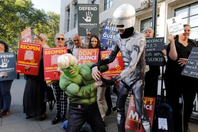 A Robocop impersonator was pictured placing handcuffs on the phoney Hulk