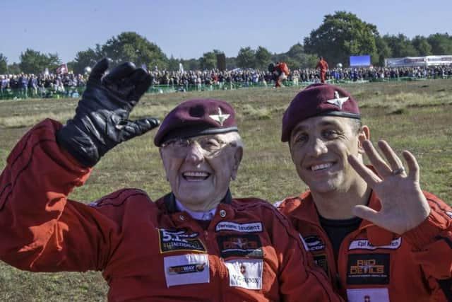 After landing Mr Cortmann, still wearing his red flight suit and returning to the area for the first time since the war, waved to onlookers and a mass of cameras from his wheelchair.