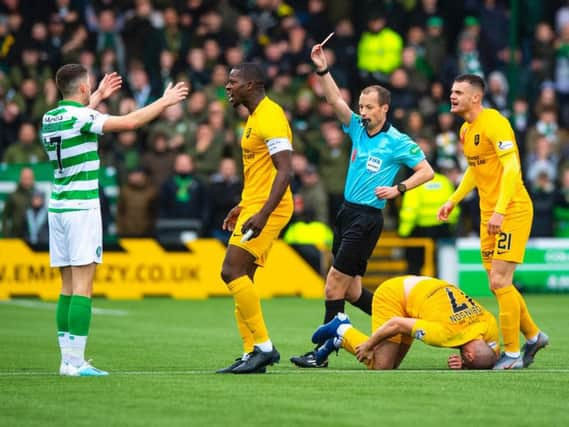 Ryan Christie is shown a red card by referee Willie Collum. Picture: SNS