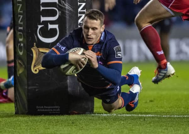 Mark Bennett dives over for a first-half try in Edinburgh's thumping win over Scarlets at Murryafield. Picture: Gary Hutchison/SNS