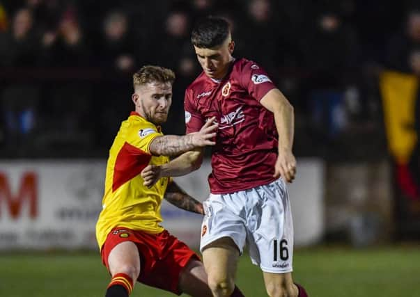 Partick Thistles Chris Slater, left, battles for the ball with Stenhousemuirs Conor McBride. Photograph: Rob Casey/SNS Group