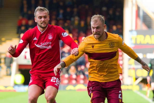 Aberdeen striker James Wilson and Motherwell's Richard Tait battle for possession in a recent match at Fir Park.