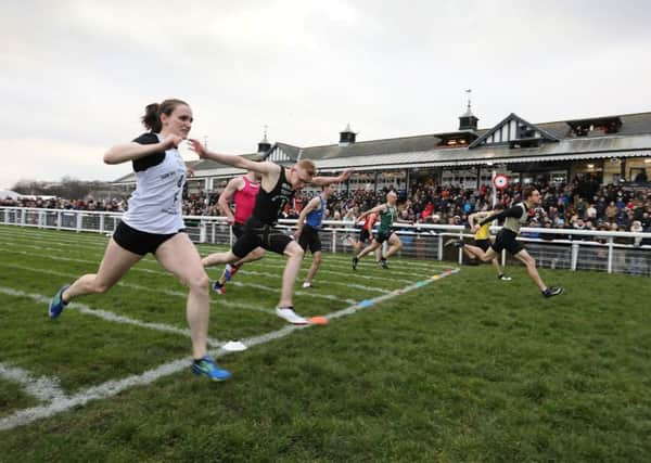 Ian Horsburgh breaks the tape just ahead of Lasswade teenager Murray Blair and Edinburghs Stacey Downie at Musselburgh racecourse yesterday. Picture: Stewart Attwood.