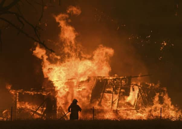 The Gospers Mountain Fire rips through a building in Bilpin, New South Wales, last month (Picture: Dan Himbrechts/AAP Images via AP)