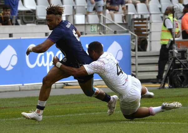 Femi Sofolarin, left, beats Englands Dan Norton to score a try during the HSBC World Rugby Sevens Series event at the Cape Town Stadium in South Africa. Picture: Rodger Bosch/AFP/Getty